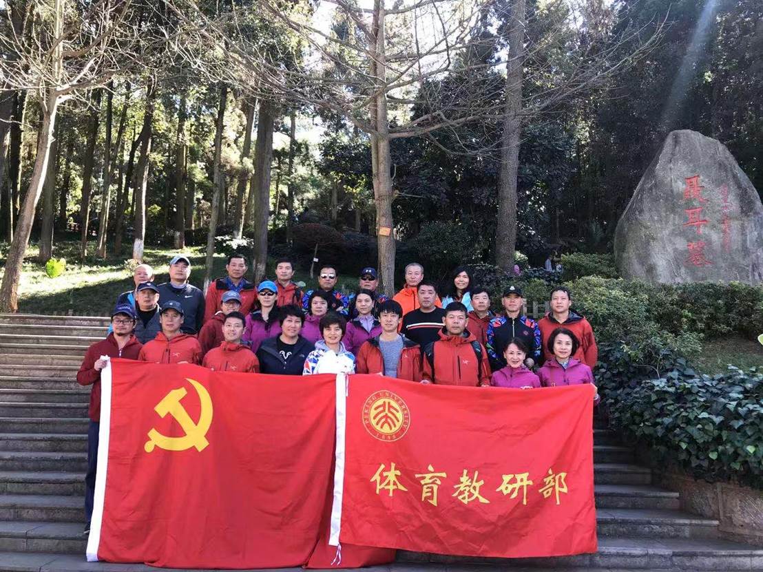 A group of people in red shirts Description automatically generated